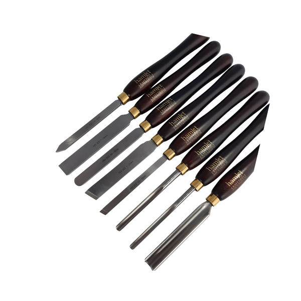 set of eight high speed steel woodturning chisels with wooden handles on a white background