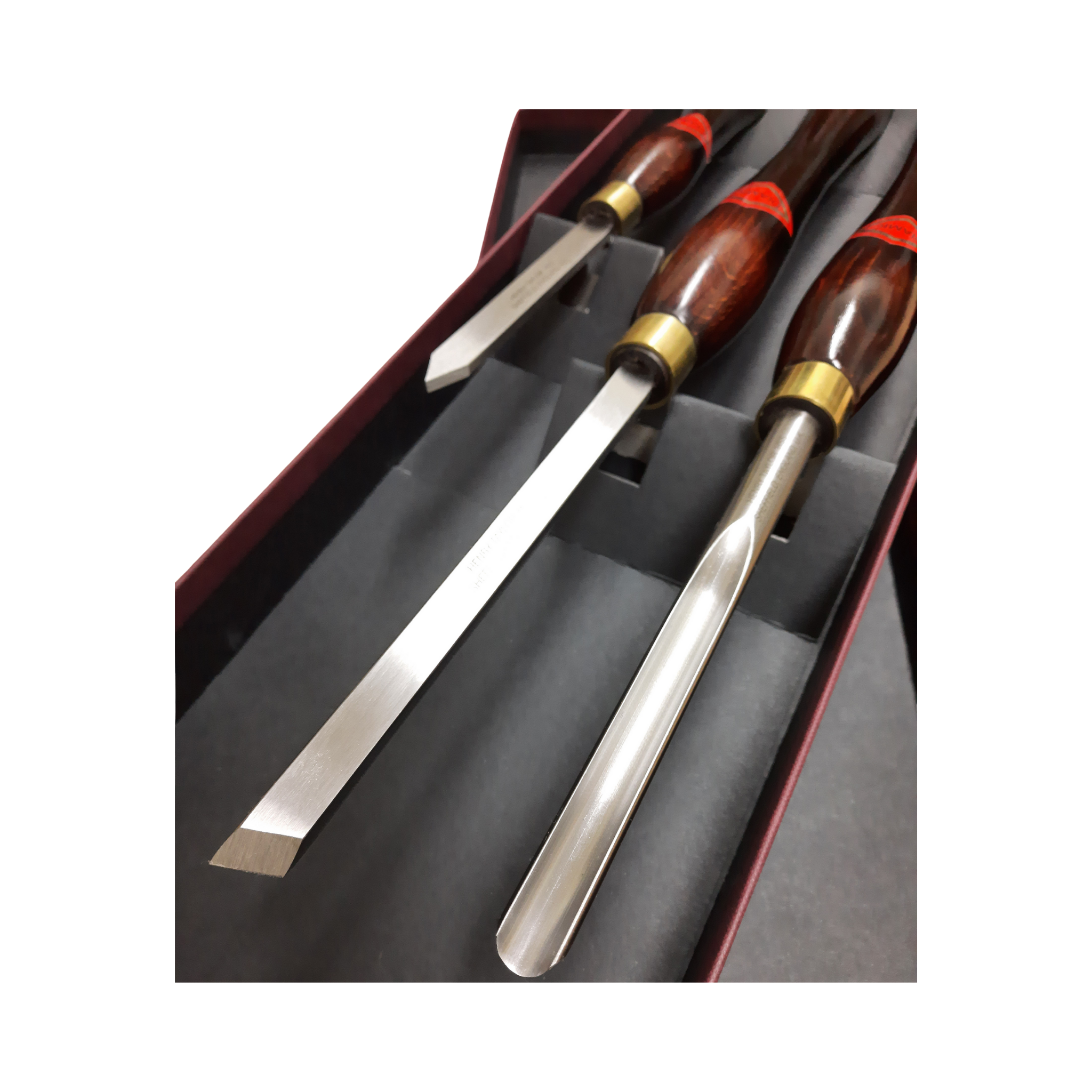 set of three woodturning chisels with high speed steel blades and wooden handles in a presentation box on a white background