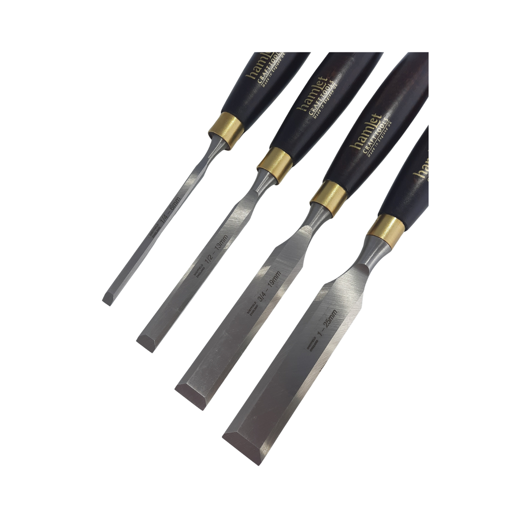 close up of a set of four wooden-handled firmer chisels with steel blades on a white background